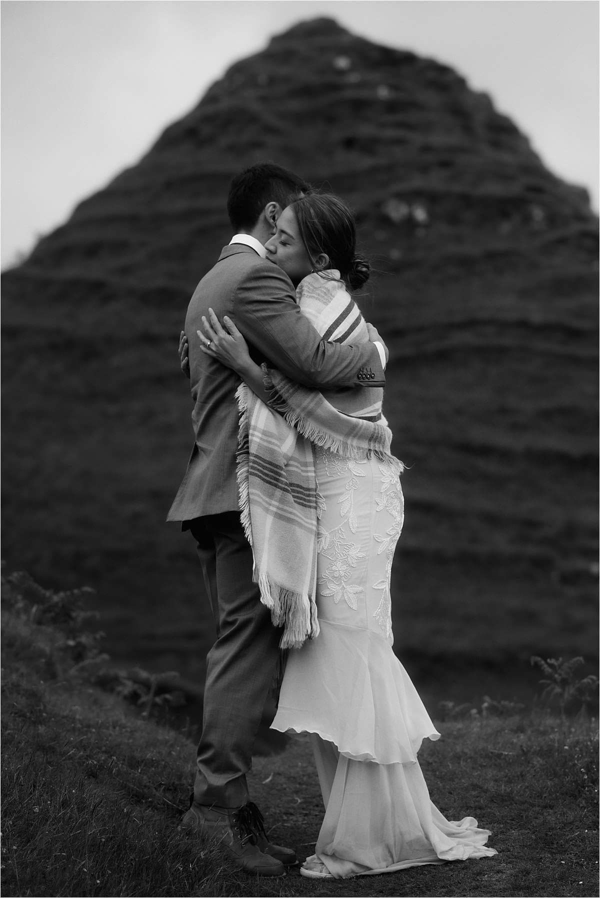 A couple hug at the fairy glen during their isle of skye elopement 