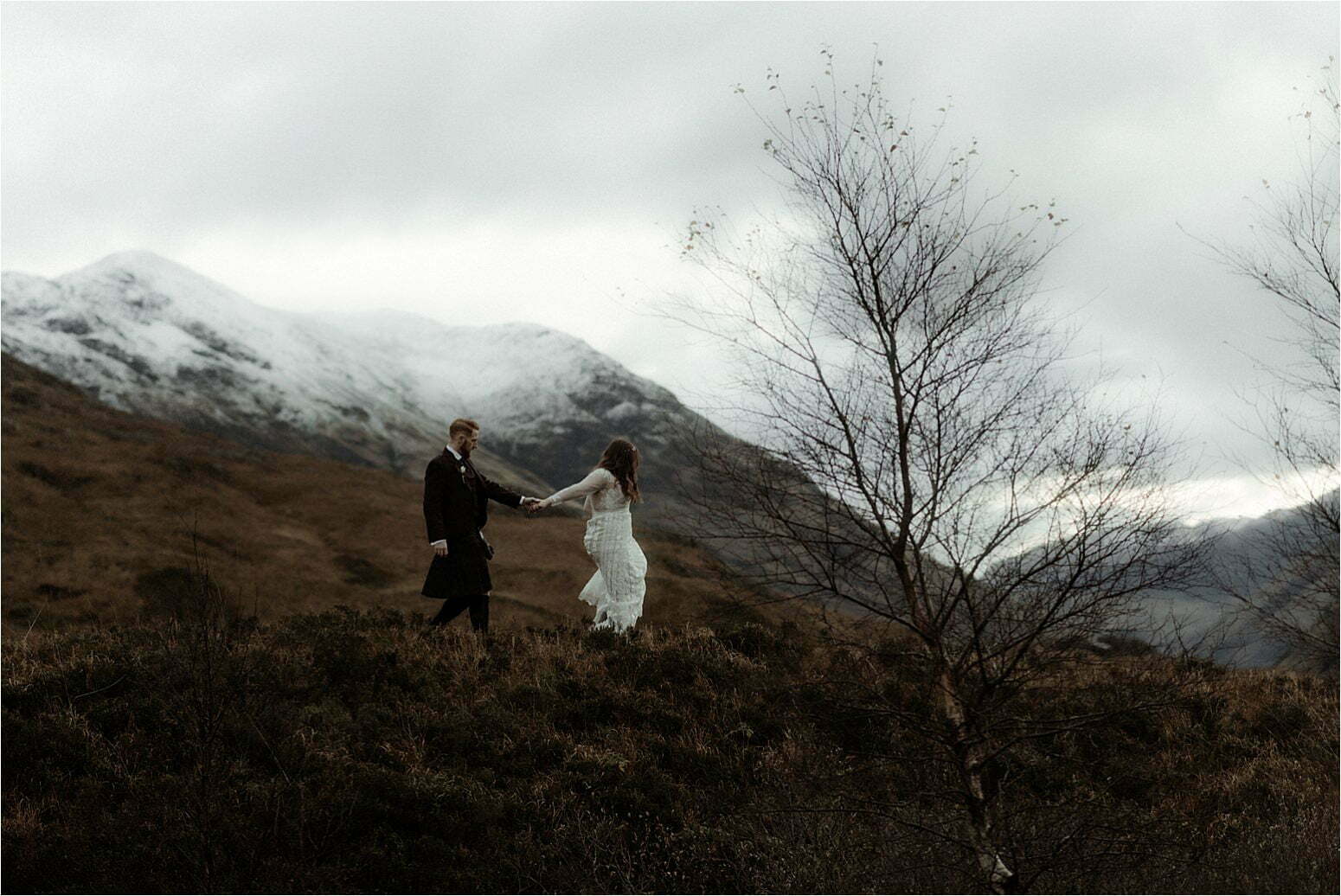 elopement in scotland couple walking in glencoe mountains