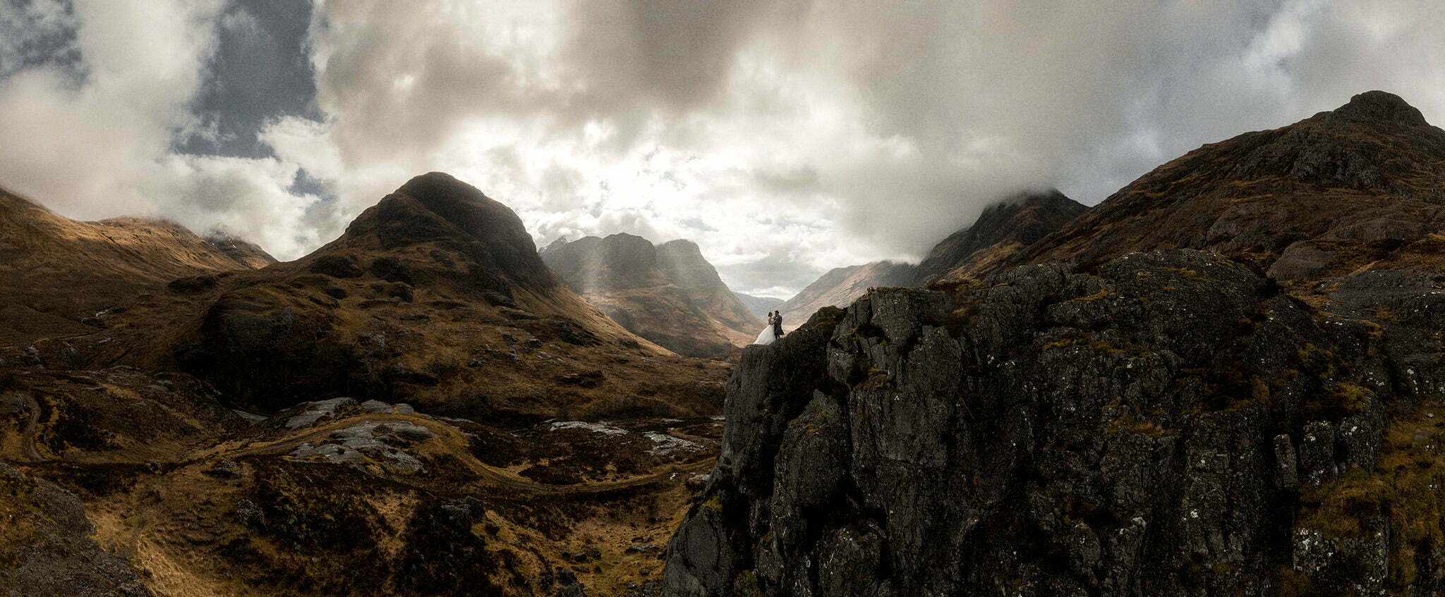 epic landscape of Glencoe with an elopement couple standing in the mountains