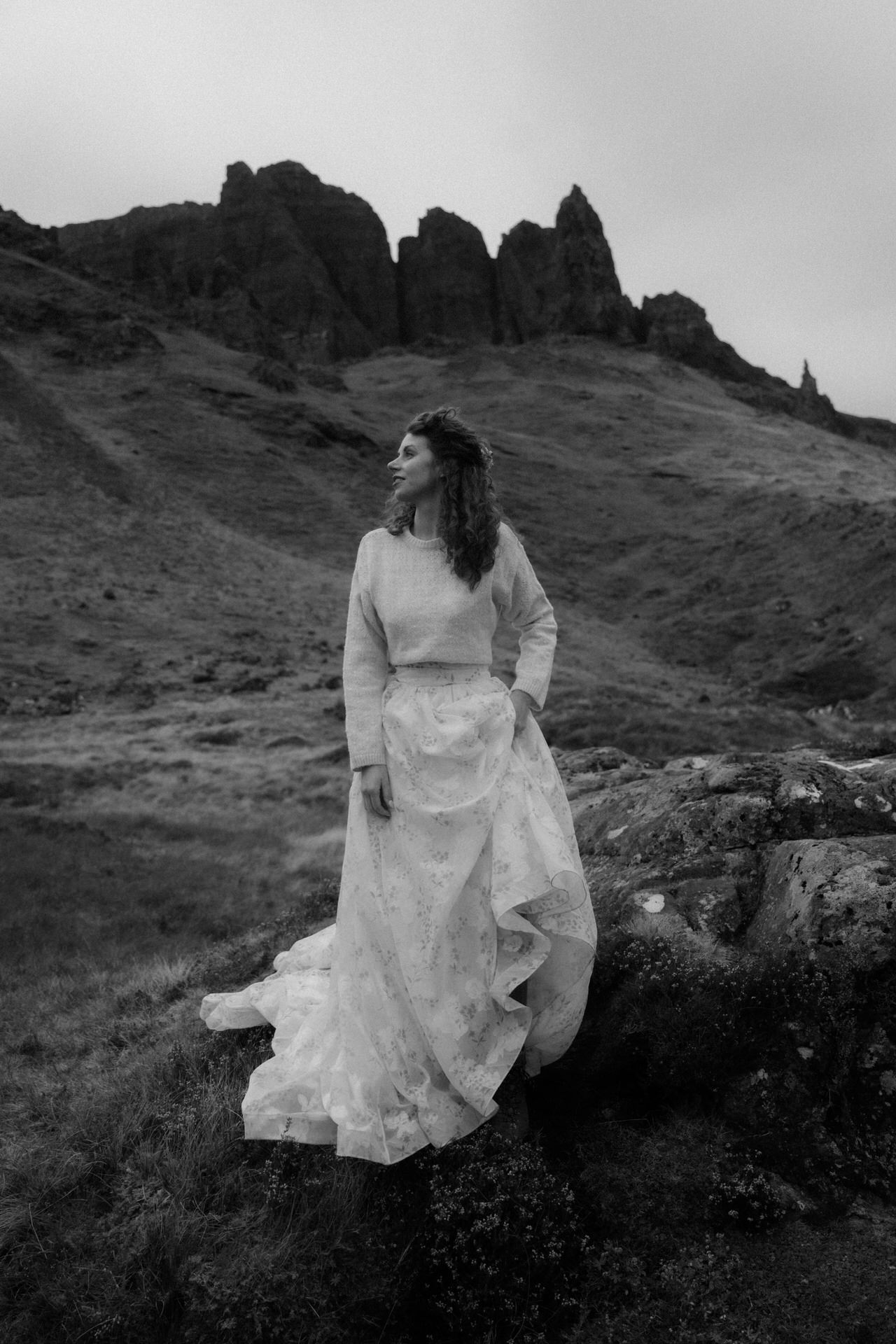 bride in scotland standing in the mountains after eloping to assynt