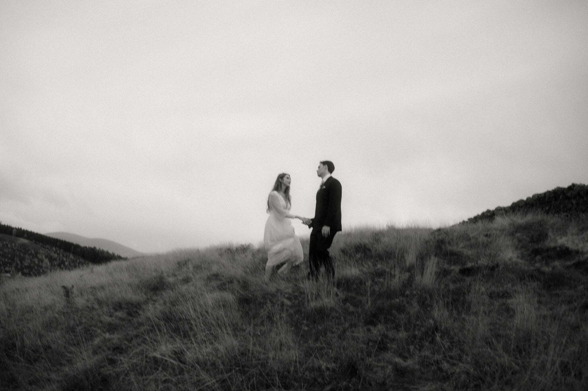 a wedding couple walking in the scottish borders during thoer scotland elopement