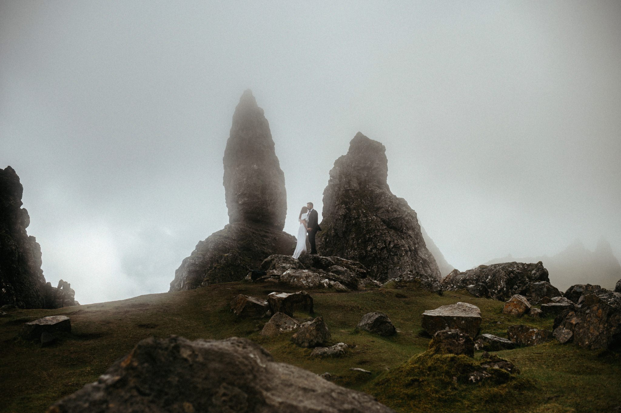Elopement in Scotland at the Old man of storr on the isle of skye with Bride and Groom kissing near the rocks