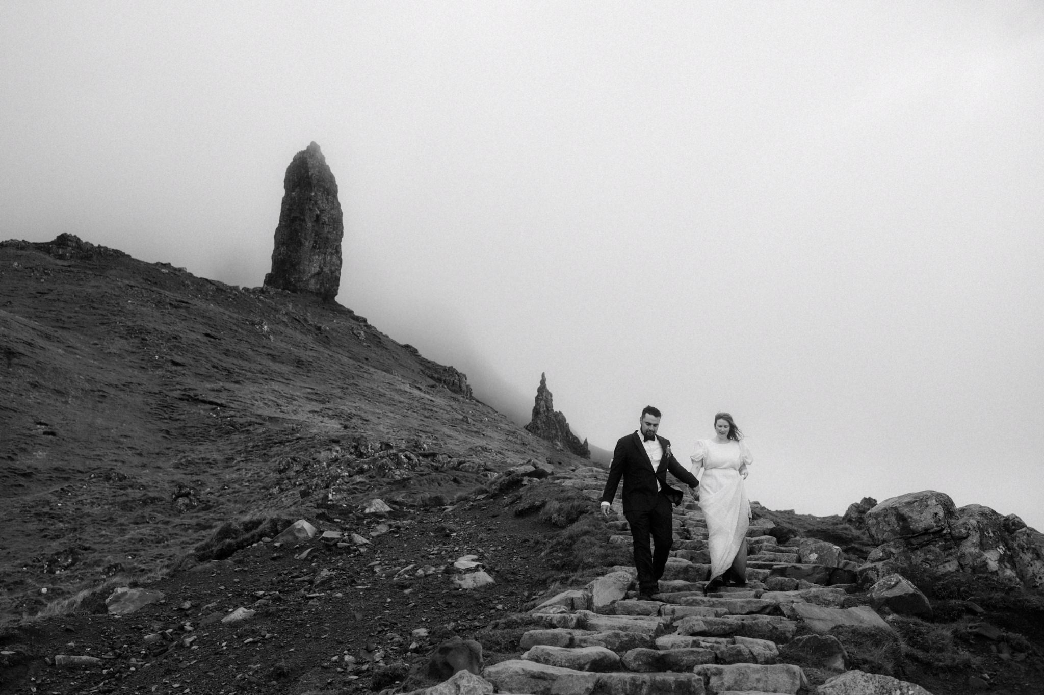 Scotland elopement photographer Sean Bell's image of Bride and Groom walking near Old man of Storr on Skye during their elopement