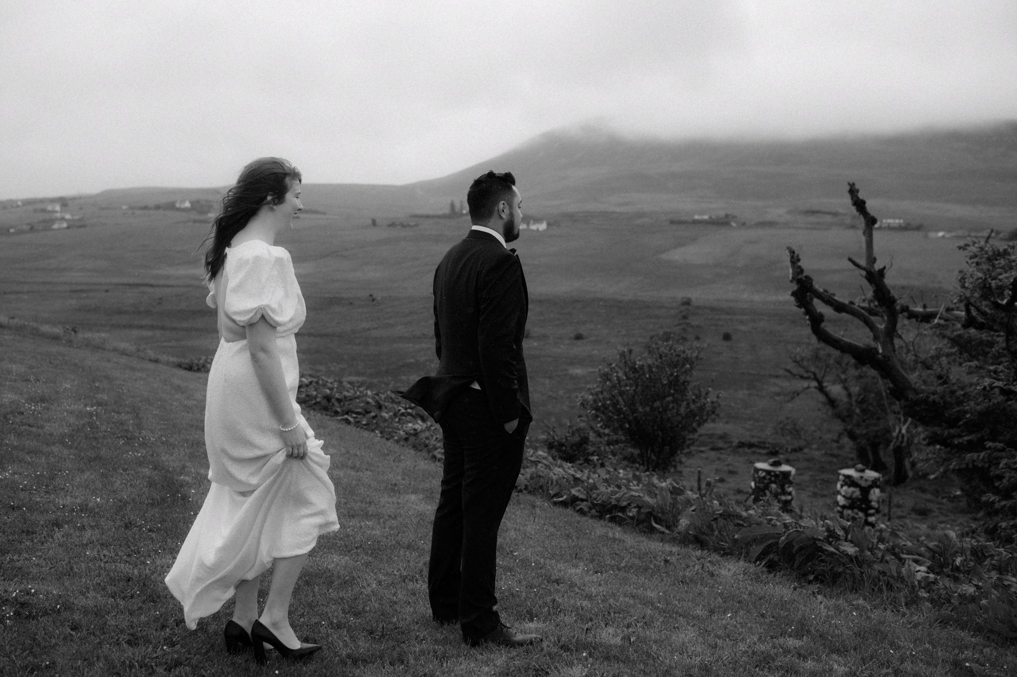 Groom waiting in the rain for a first look during Skye elopement
