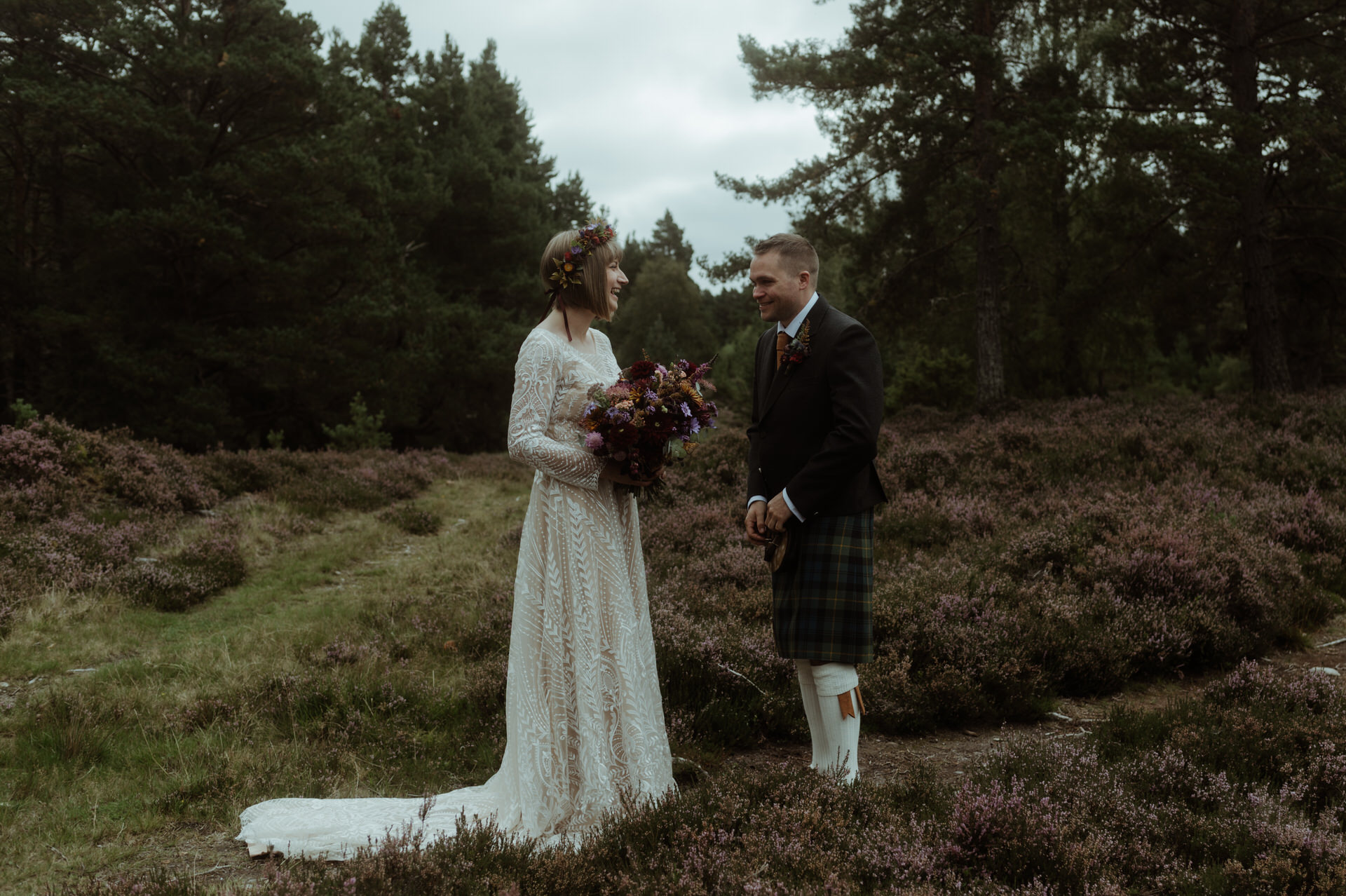 Bride and groom laughing in woodlands in Scotland