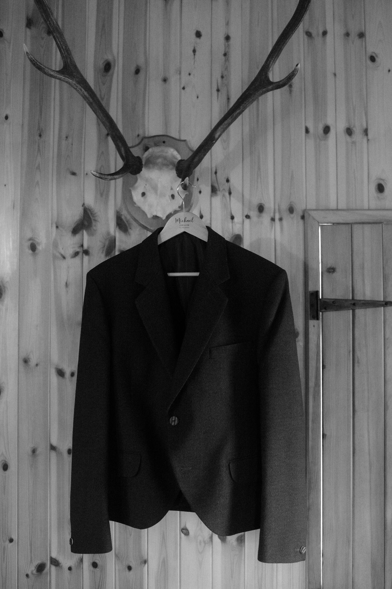 grooms jacket on stag antlers in the cairngorm's