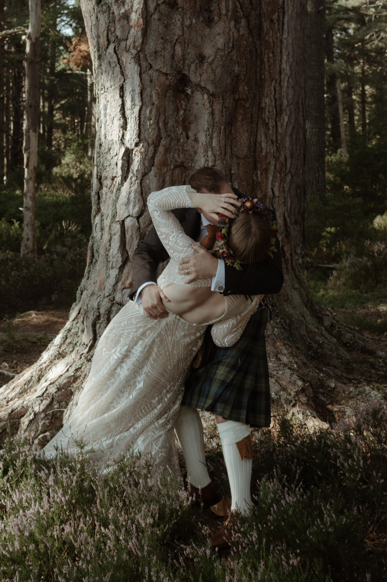 Bride and Groom laughing whilst exploring the woodland on a Sunny day during their Scottish elopement