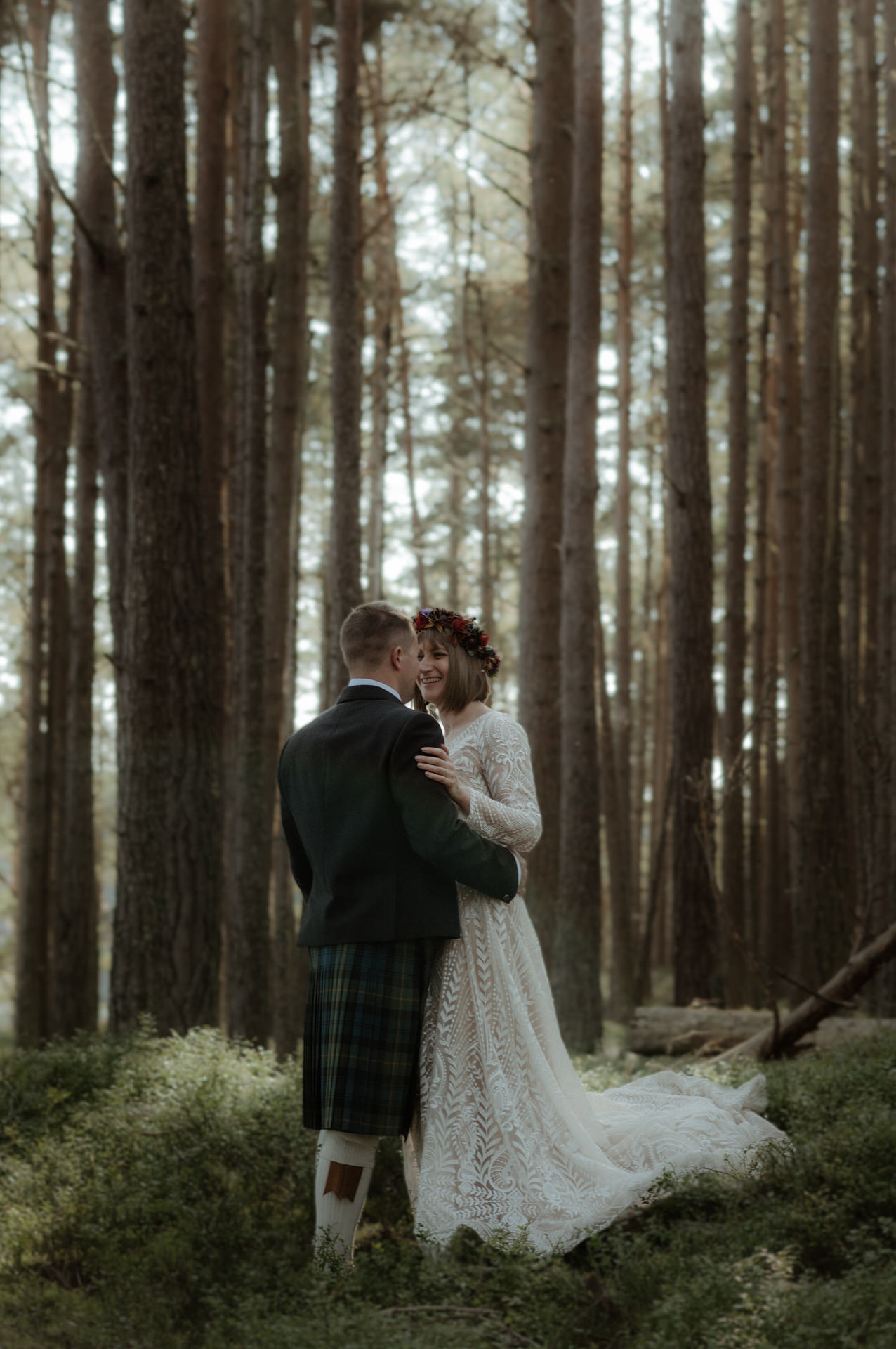 Bride and Groom walking in Woodland in the Cairngorm's national park on a Sunny day during their Scottish elopement