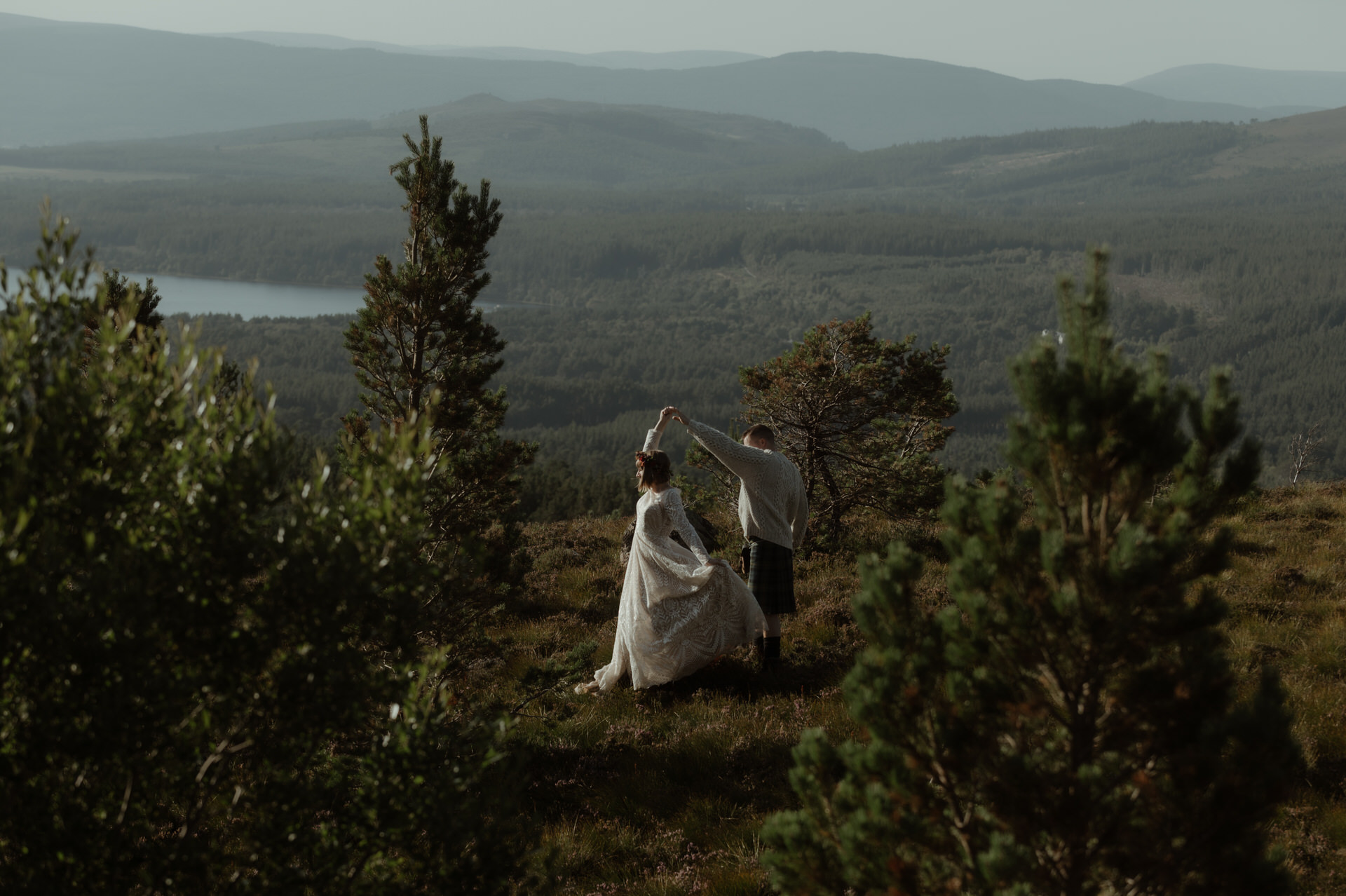 Bride and Groom dancing in the mountains of Scotland during their wedding day