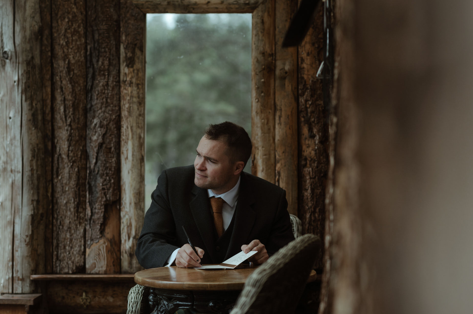 A groom writing his vows before a Cairngorms elopement