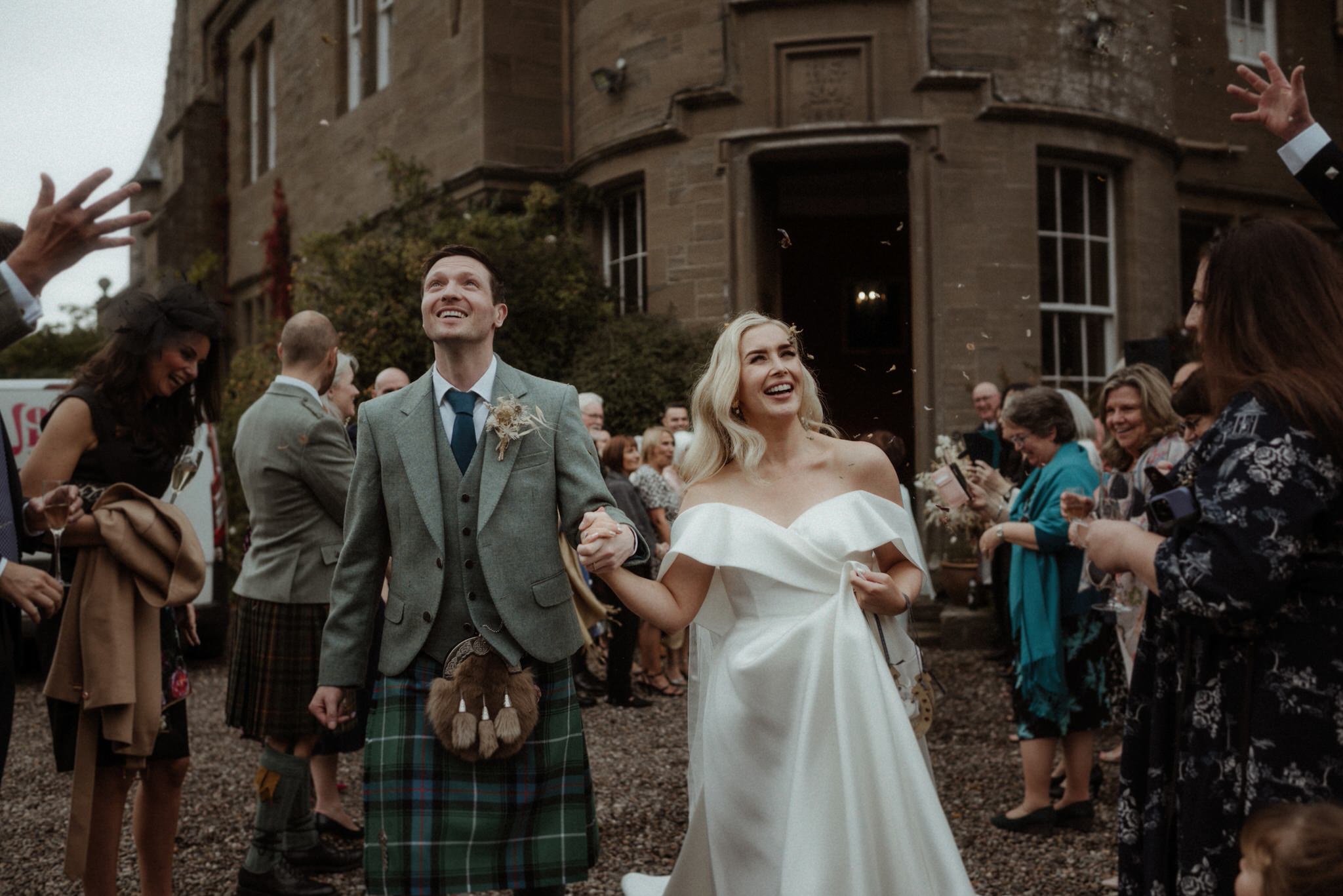 confetti throw during a wedding at birkhill house in Scotland with Bride and groom running and laughing