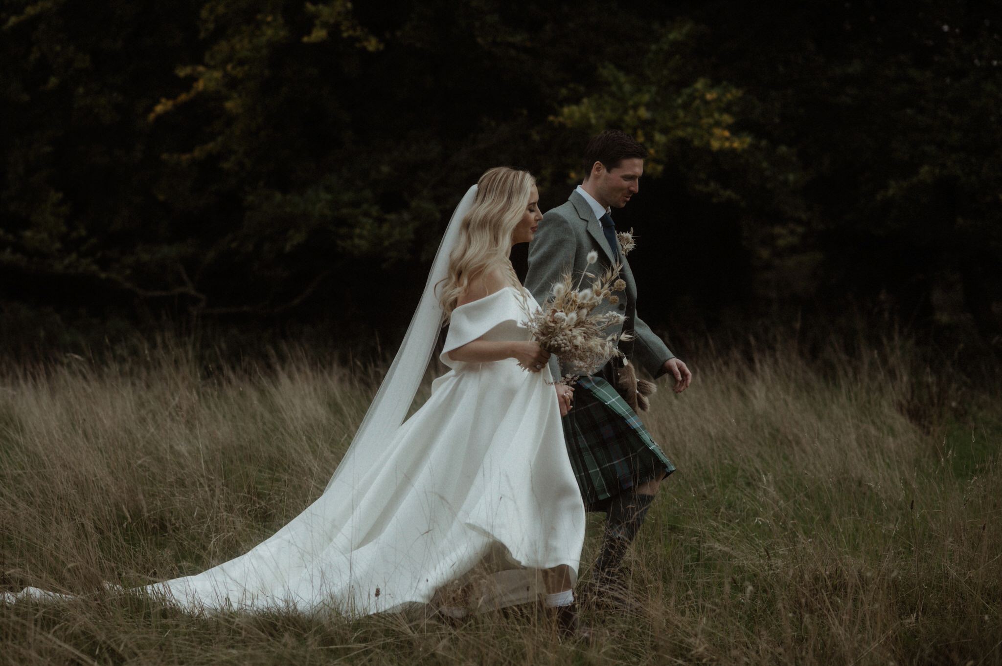  image of bride and groom wandering next to Birkhill house 