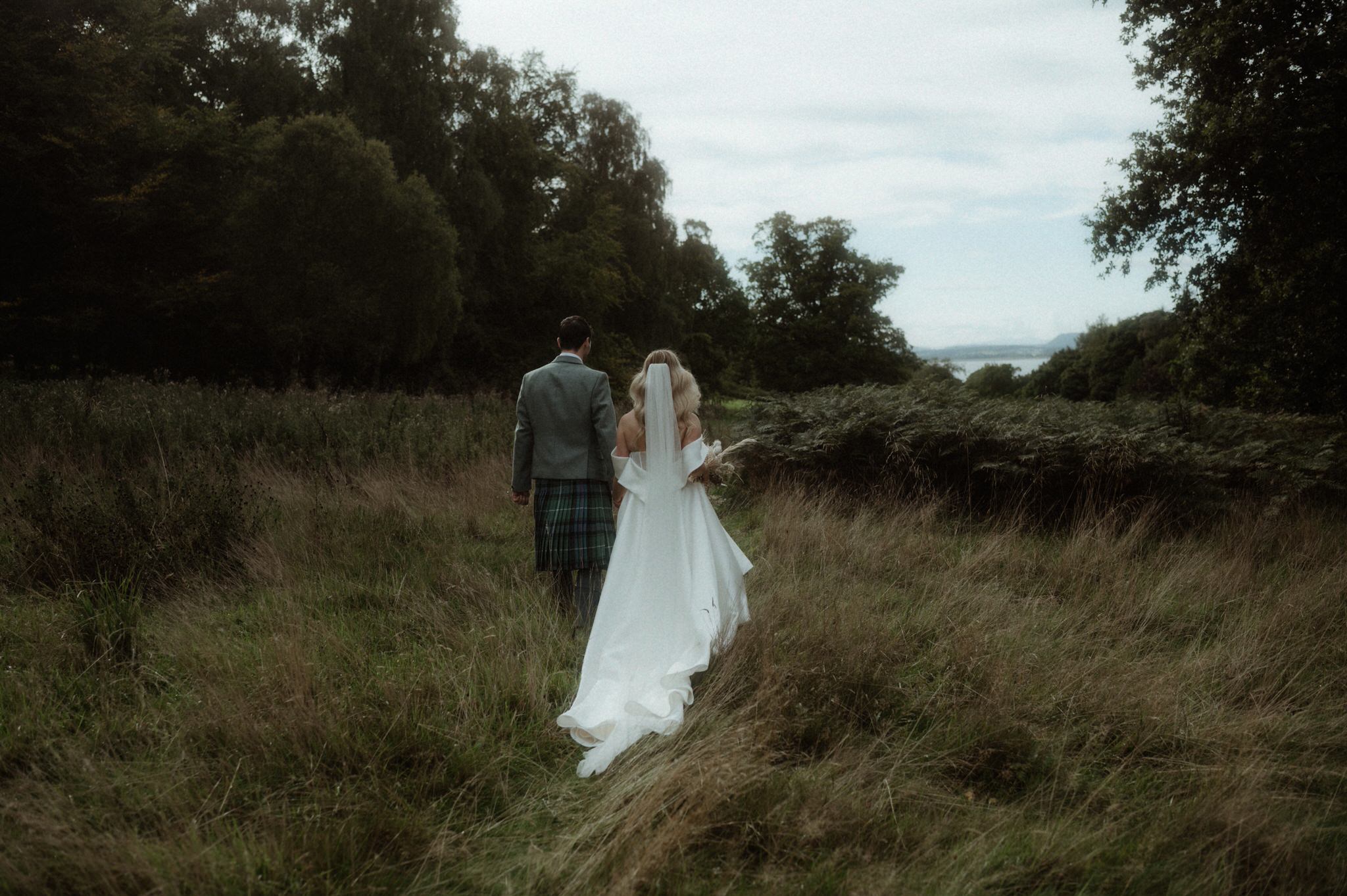  image of bride and groom wandering next to Birkhill house 