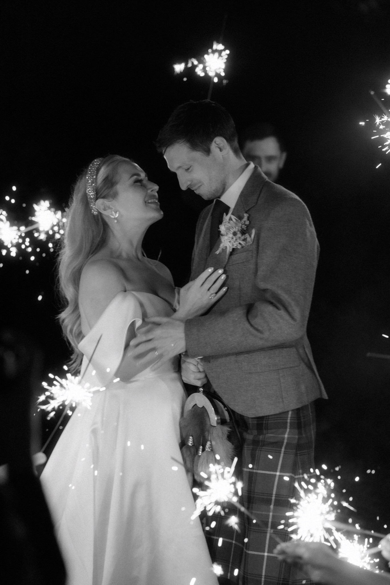 bride and groom dancing and running in sparklers during their wedding day in Scotland