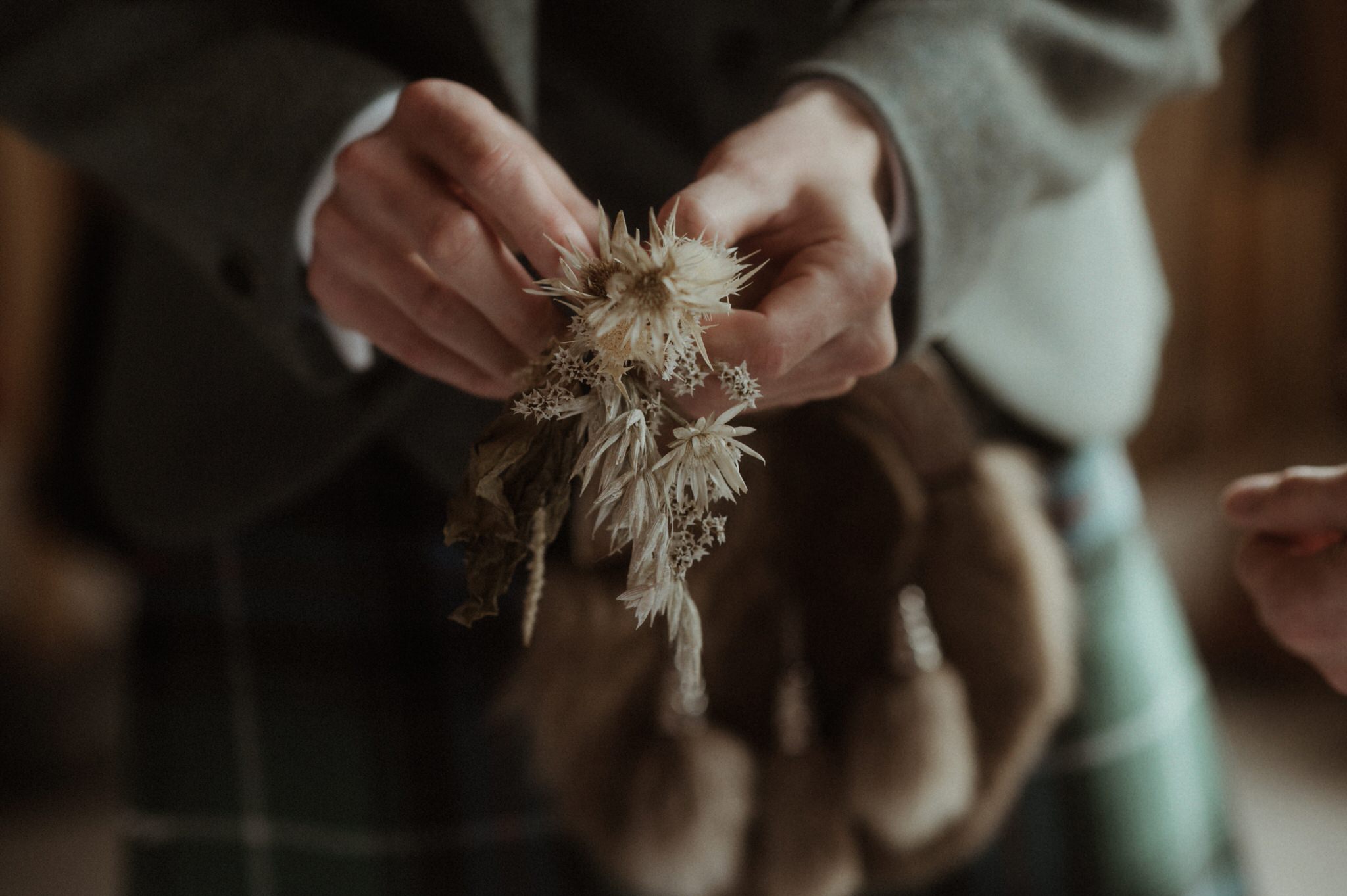 groom holding a buttonhole 