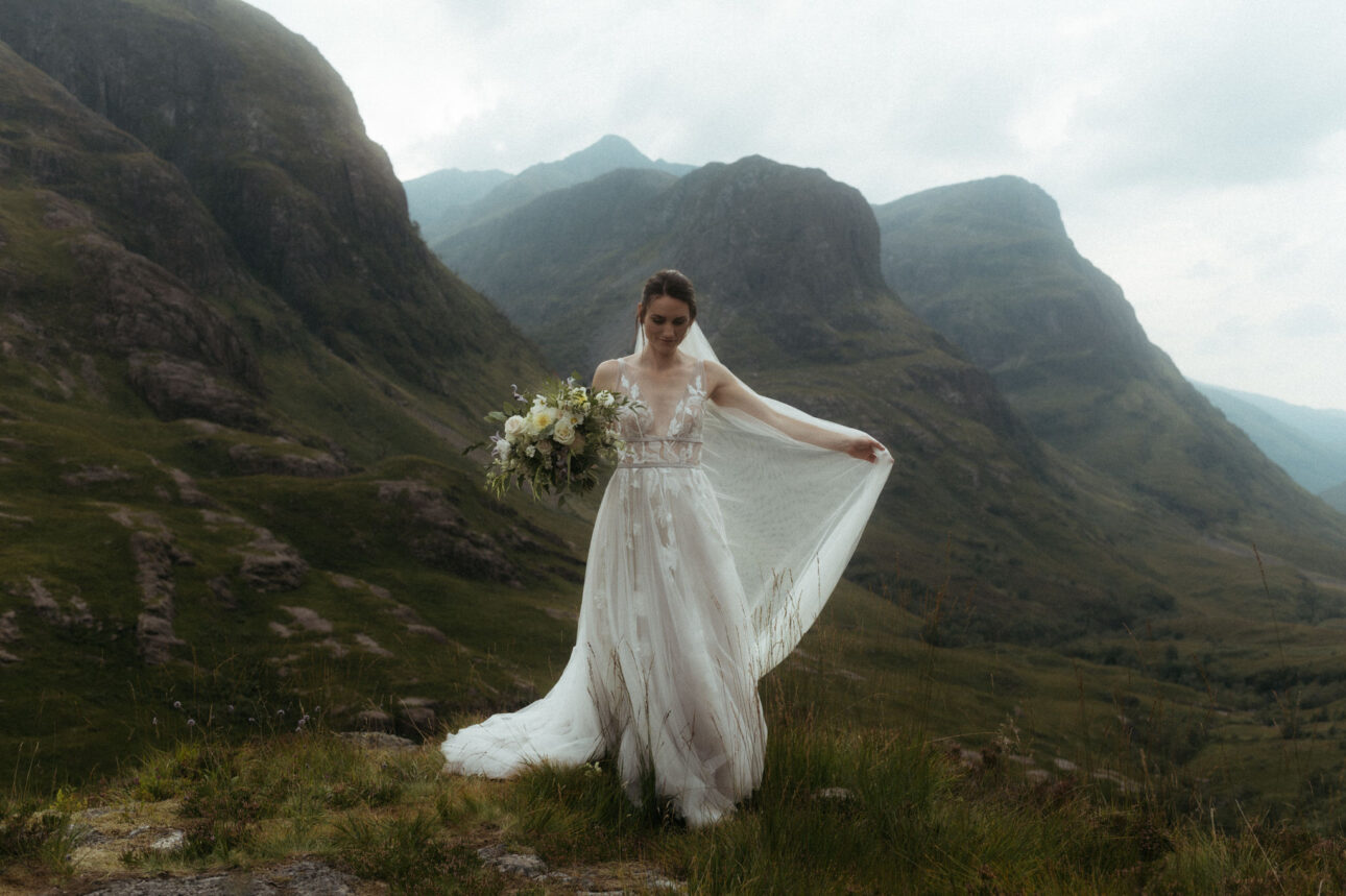 a bride walking in the mountains of Glencoe during an elope to scotland