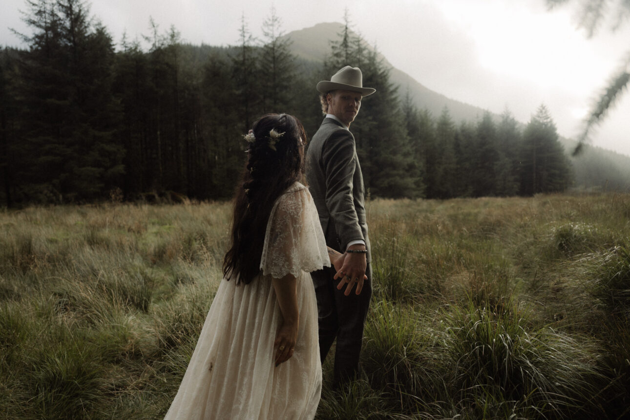 scotland elopement couple walking in woodland near to Loch Lomond during their elopement in scotland