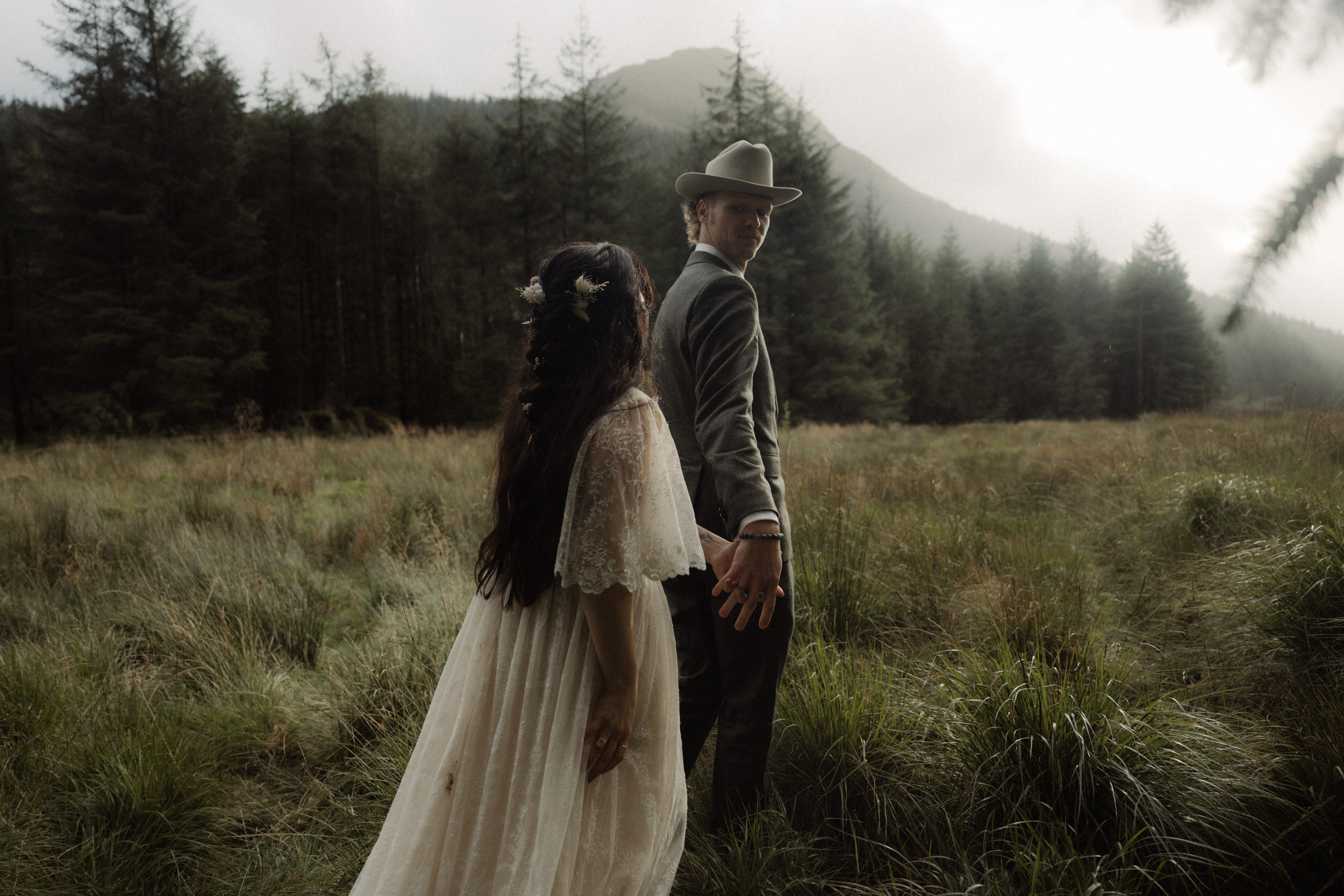 scotland elopement couple walking in woodland near to Loch Lomond during their elopement in scotland