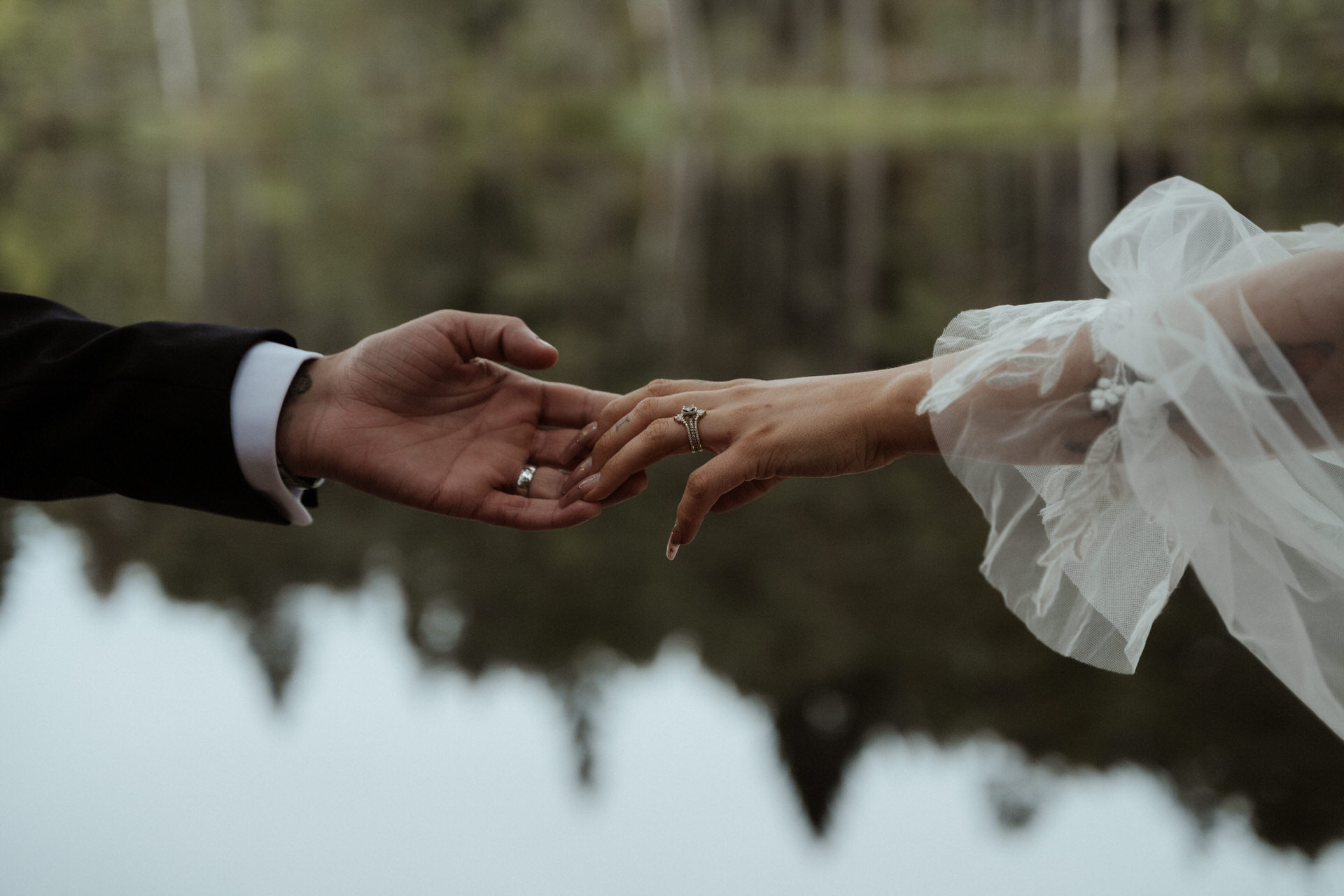elope to scotland couple holding hands next to a loch in the cairngorms