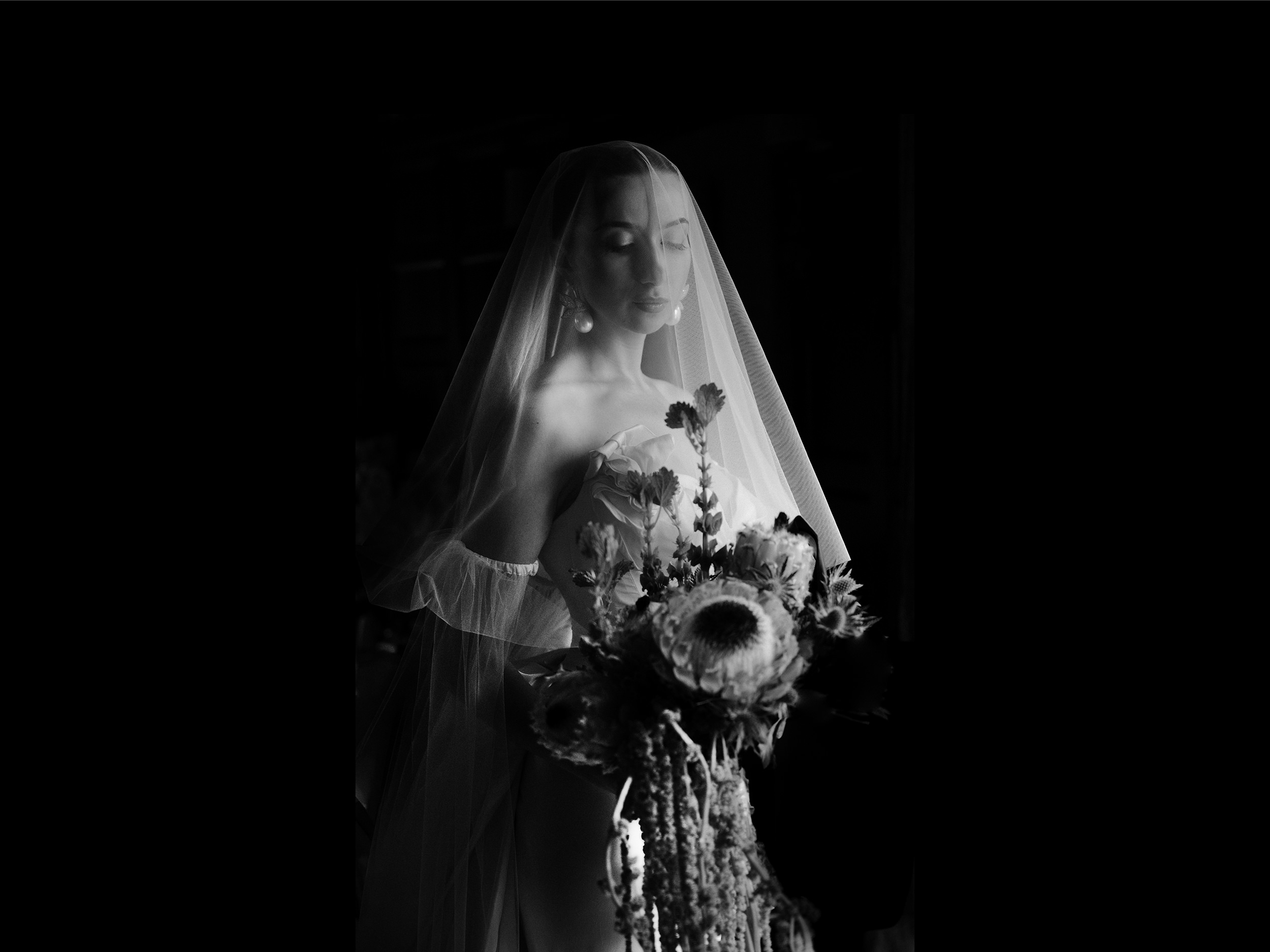 Bride holding bouquet in black and white image